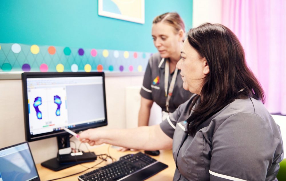 two clinicians, look at foot gait and biomechanics at the Acclerate centre for exellence in Hackney, London